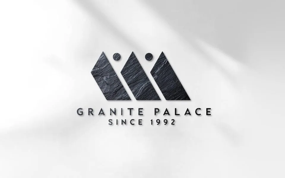 Granite Palace logo in carved dark stone on a light wall